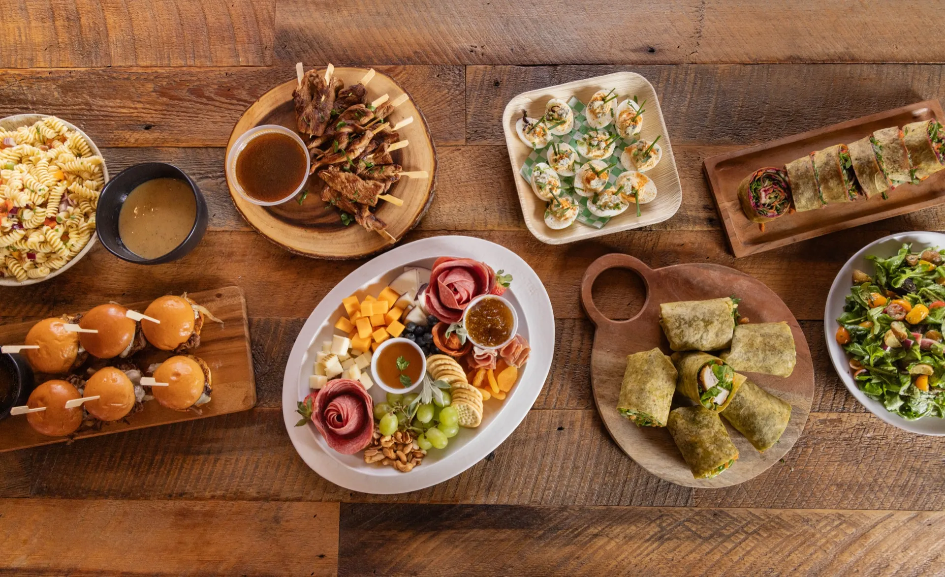 Overhead view of the Deli Nerds menu spread — sliders, salads, platters, and wraps
